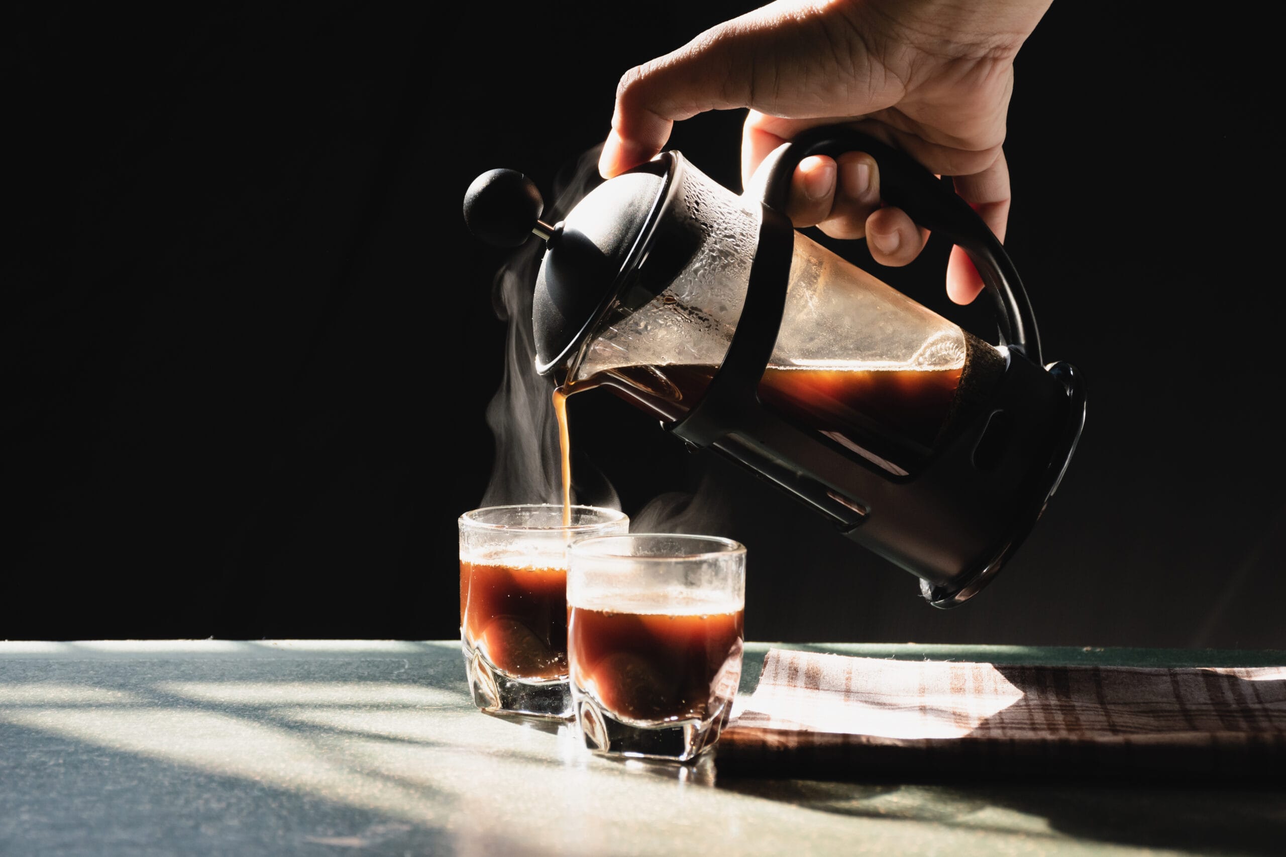 Aromatic,Coffees,With,Hot,Smoke,Are,Poured,Into,Couple,Cup how to use a french press; how to make french press coffee; how to use a french press coffee maker; how to use french press; how to brew with a french press